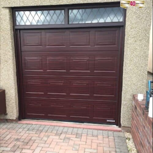 Garador Georgian Sectional Garage Door iin Rosewood with Custom Top Glazing Section and Fascia