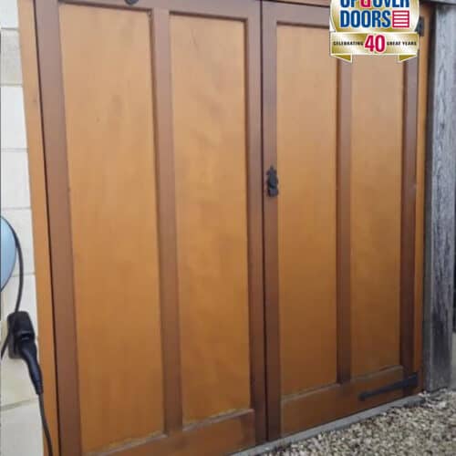 Cedar Door Side-Hinged Garage Door, Hope style with Antique hardware fully finished in Light Oak Stain.