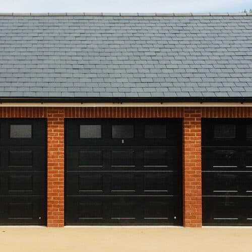 3-Georgian-Style-Insulated-Sectional-Garage-Doors-in-Jet-Black-with-Top-Panel-Glazing