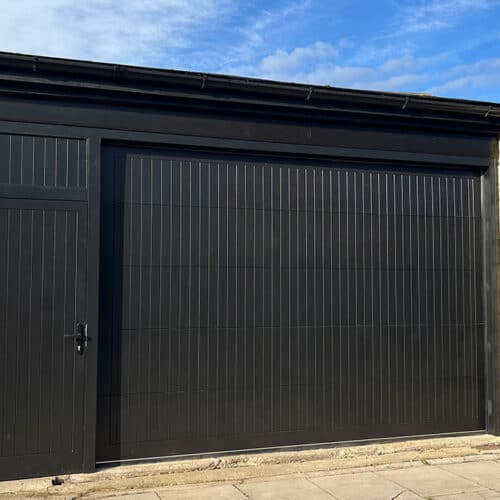 Custom Black Solid Timber Sectional Garage Door with Matching Side Door and Infill Section